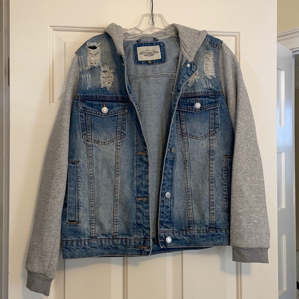 Distressed denim jacket with gray sweatshirt sleeves and hood. Medium.